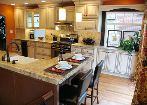 Classic creamy kitchen cabinets with orange walls and espresso window trim