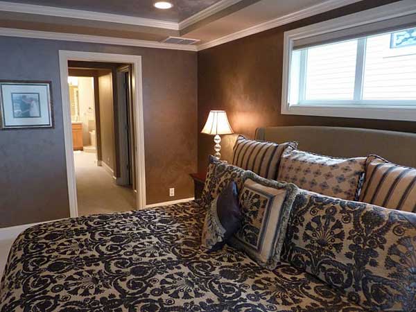 This Sammamish homeowners retire to hotel romance and drama every night in their master bedroom with deep mocha walls.